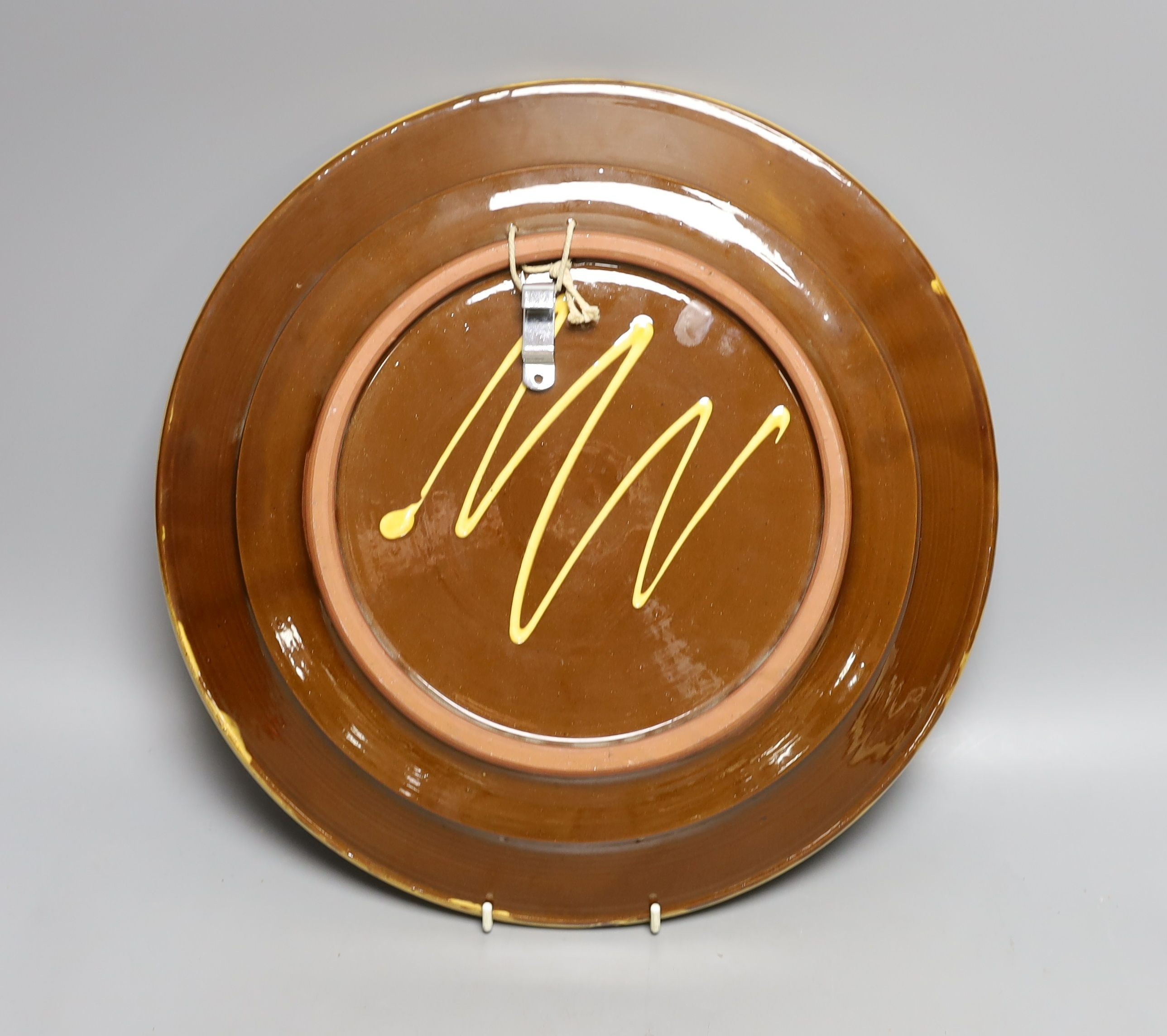 A Queen Elizabeth II silver jubilee commemorative large slipware charger, 1977, 36 cms diameter.